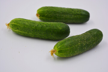 Young juicy cucumbers, Ukrainian cucumber harvest arranged on a white background. Fresh vegetables, healthy food for every day.