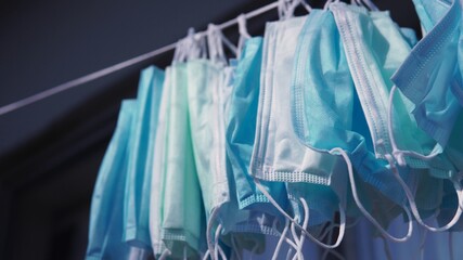 Hanging disposable masks hanging outside for disinfection and sterilization. Concept of new normal,...