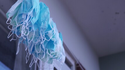 Pile of medical face masks after laundry drying on the sun. Used PPE personal protective equipment...