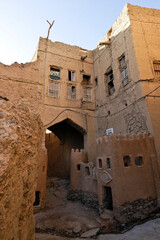 Crumbling mud-brick buildings in old section of Al-Hamra, Oman