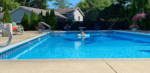 swimming pool woman floating relaxing meditating looking into sun