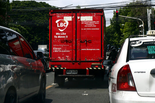 Delivery truck of popular delivery or courier service company at a traffic congested road