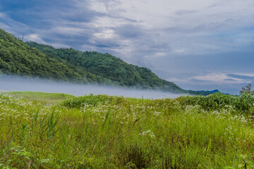 Fototapeta na wymiar Foggy river under clouds