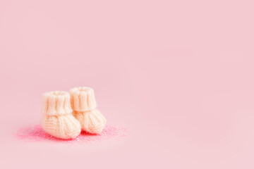 Baby shoes, booties on pink background, first newborn party background, birthday, expectation of...