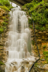 Fototapeta na wymiar Beautiful natural waterfall cascading down a hill.