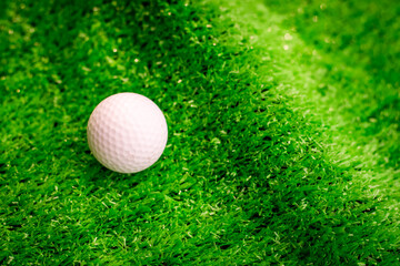 Golf ball on green grass