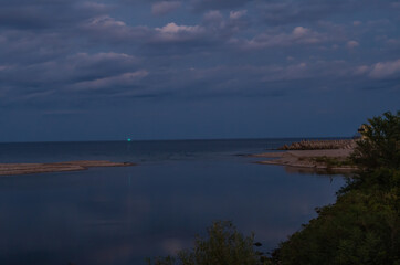 Clouds over a calm inlet cove