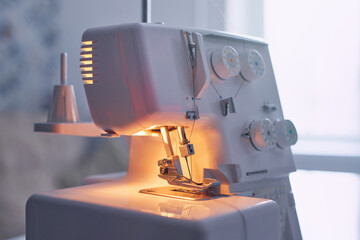 Close-up of sewing machine and sewing needle in fashion design studio