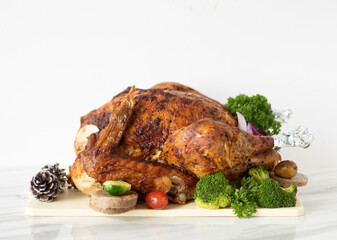 Roasted Christmas Turkey on White Background with Copy Space. Thanksgiving Turkey with Vegetables and Side Dishes. Family Thanksgiving Meal.