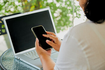 woman using mobile smart phone and notebook