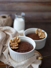 Homemade Brownies in Ramekins. Round Brownies and Milk with Wooden Background. Side View of Brownies with Copy Space.