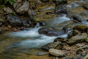 Fototapeta na wymiar Waterfall in small mountain stream.