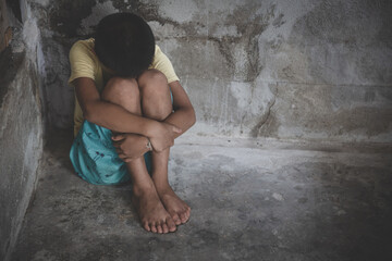 Fototapeta na wymiar The girl sat depressed in a dark room, Violence against children, Domestic violence, Stop Sexual abuse And human trafficking Concept, stop violence against Women, international women's day