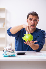 Fototapeta premium Young man in budget planning concept