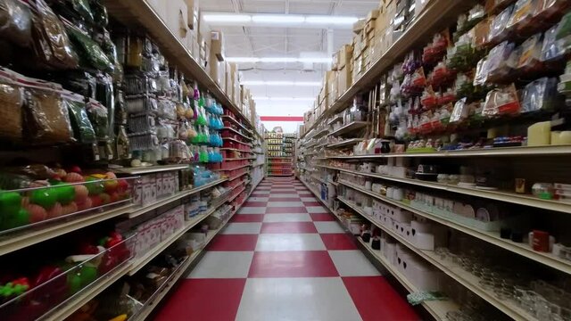 Supermarket shopping pov action camera motion in the row of the store. Section of the shop with a lot of products to select. Aisle front view flow. 4k