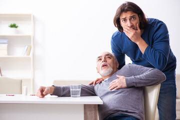 Grandfather and grandson in first aid concept