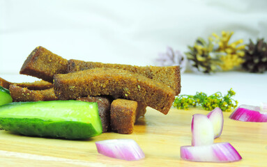 salted cucumbers, fried croutons of rye bread, red onions and dill, selective focus