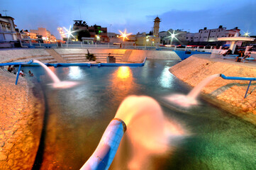 Water irrigation stream for farms, palm trees and water springs for swimming