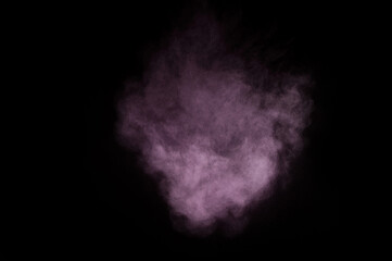 Purple powder explosion on black background. Colored powder cloud. Colorful dust explode. Paint Holi.
