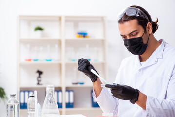 Young male chemist working in the lab