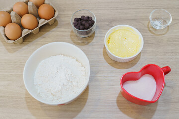 Ingredients for baking, flour egg chocolate and sugar. Cooking flat lay with copy space.