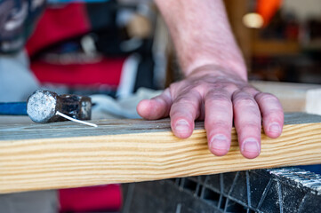 bent nail into a wooden board with a hammer
