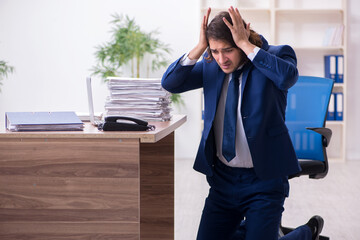 Young male employee unhappy with excessive work