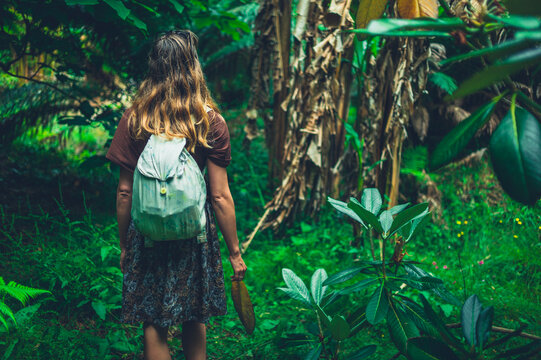 Young woman exploring a tropical garden