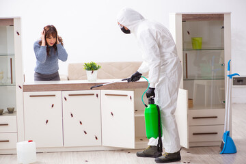 Young male contractor and female client during pest control