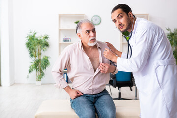 Old man visiting young male doctor cardiologist