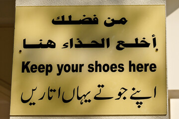 Fototapeta premium Sign in Arabic and English outside mosque in Dubai, United Arab Emirates