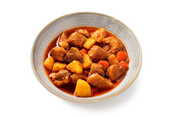 Pork meat stewed with potatoes, carrots and spices (hungarian goulash). isolated on white background