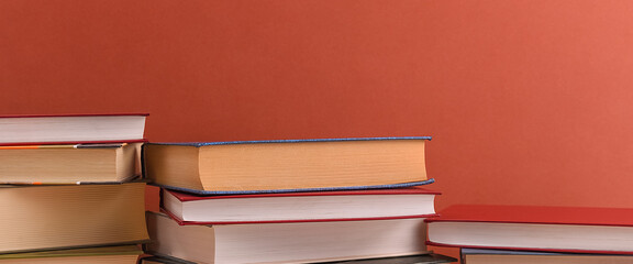 Stacks of books several on a brown background close-up. Back to school, education, learning,