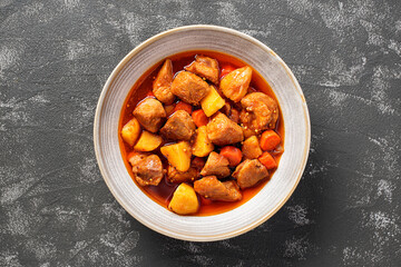 Pork meat stewed with potatoes, carrots and spices (hungarian goulash).