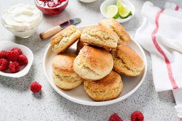 Scones with raspberry jam and clotted cream.
