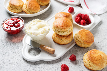 Scones with raspberry jam and clotted cream.