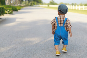 Asian toddler boy walking lonely