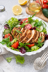 Grilled chicken breast, fillet and fresh vegetable salad. Healthy lunch menu.	
