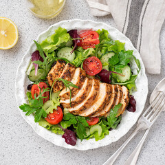 Grilled chicken breast, fillet and fresh vegetable salad. Healthy lunch menu.	
