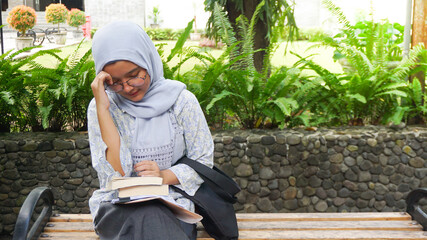 Asian hijab girl is dizzy because she is taking an exam