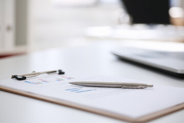 Financial statistics documents on clipboard pad at office table closeup. Internal Revenue Service inspector sum check, irs investigation, exchange market, earnings, savings, loan and credit concept