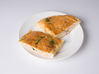 Omelette pieces on a white round plate. Delicious breakfast