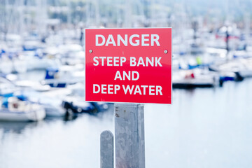 Danger deep water and steep bank at sea harbour marina