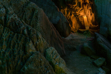 Lit candle in cave