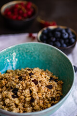 Breakfast food concept with cereals, yogurt and berries on concrete background with copy space