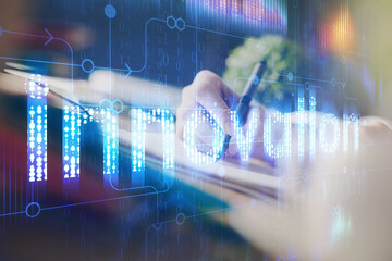 Double exposure of hands making notes background with technology and digital coding huds. Data learning concept.