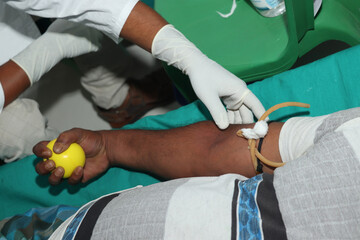 Blood donor at donation with a bouncy ball holding in hand stock photo