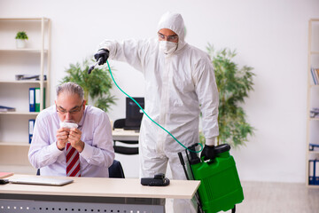 Old employee catching coronavirus at workplace