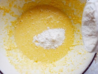 bowl with dough and flour with glass above