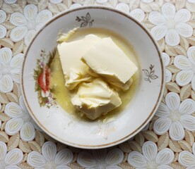 plate with butter on table with tablecloth